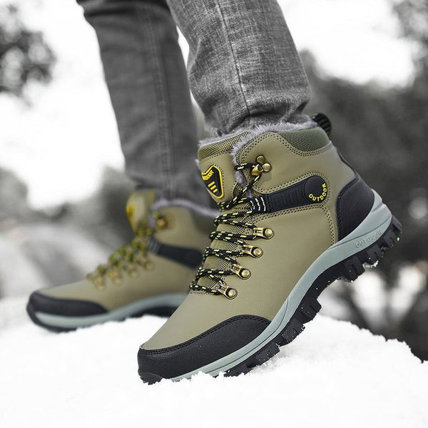 Warm plush ankle boots for men in snowy outdoors, showcasing hiking lace-up design.