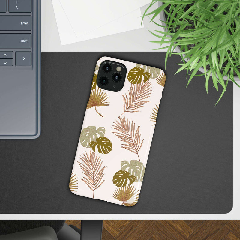 Nature-Inspired Mobile Phone Case with tropical leaf design on desk.