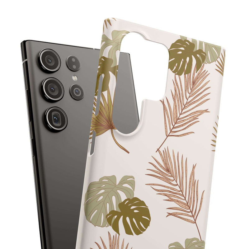 Nature-inspired mobile phone case with tropical leaf design, sleek and durable polycarbonate, supports wireless charging, compatible with iPhone 16 series.