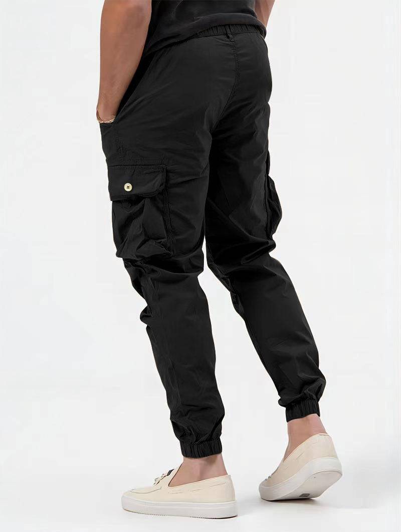 Men's black cargo trousers with 3D pockets, versatile solid color casual pants.