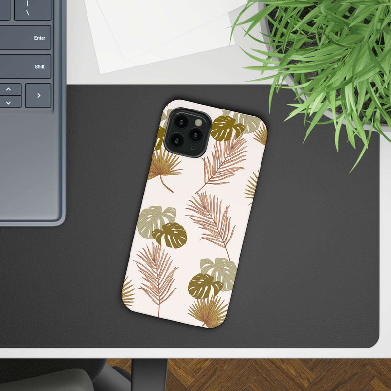 Nature-Inspired Mobile Phone Case with tropical leaf design on table.