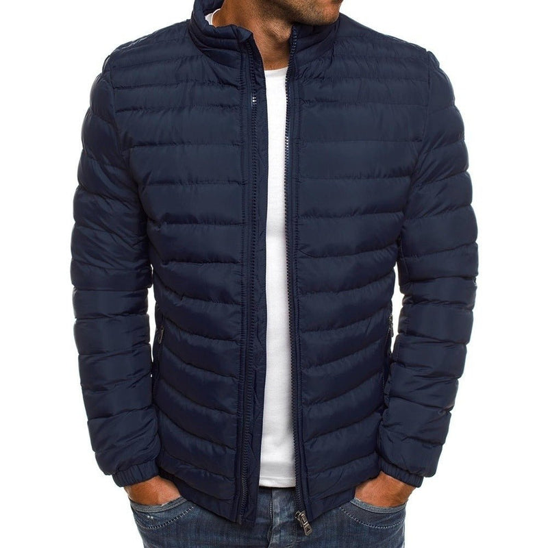 Men's cold-weather insulated jacket in navy blue, padded for warmth, features secure zippered pockets, ideal for winter fashion.