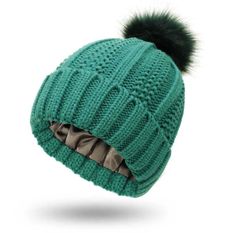 Satin-lined green beanie with faux fur pom pom, knit design.