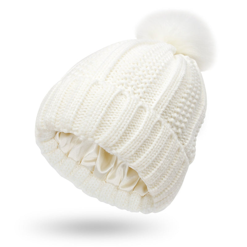 White satin-lined beanie with faux fur pom pom, knitted wool design, winter hat.