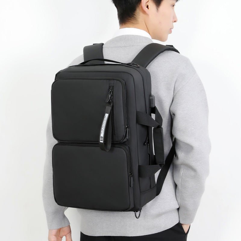 Multifunctional large capacity black laptop bag worn by person, suitable for business, school, and travel.